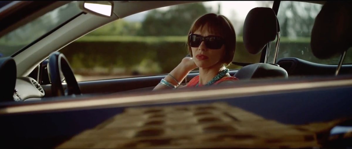 A woman wearing sunglasses in a car — Shadow Wars film still
