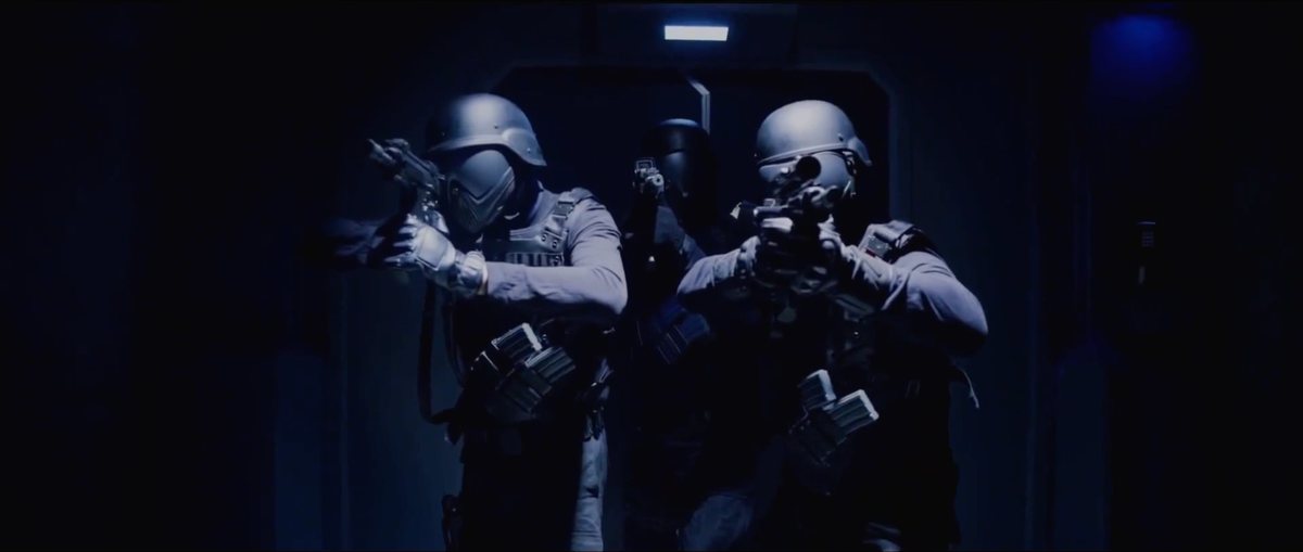 Armoured figures in a blue-lit corridor — Shadow Wars film still